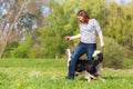 Woman plays with two dogs on the meadow Royalty Free Stock Photo