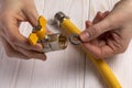 Woman plumber demonstrates a gas stopcock with internal female thread and a gasket.