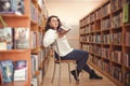 Plus size elegant woman in white shirt in library