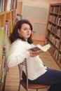 Plus size elegant woman in white shirt in library
