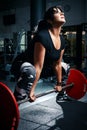 Woman plus size in gym doing exercises with barbell powerlift, f Royalty Free Stock Photo