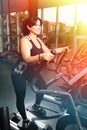 Woman plus size in gym doing exercises with running training app