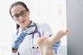 Woman podiatrist examining heel of patient using magnifying glass