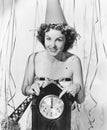 Woman pointing at the clock at midnight Royalty Free Stock Photo