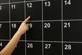 Woman pointing on date of board calendar Royalty Free Stock Photo