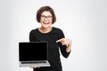 Woman pointing finger on blank laptop computer screen Royalty Free Stock Photo