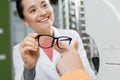 woman pointing with finger at eyeglasses