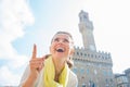 Woman pointing in front of palazzo vecchio, Italy Royalty Free Stock Photo