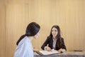 Woman pointing at the guest list to her client