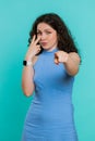 Woman pointing at her eyes and camera show I am watching you gesture spying watching on someone Royalty Free Stock Photo