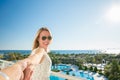 Woman is pointing with her finger to the sea from a balkony in summer holiday Royalty Free Stock Photo