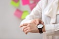 Woman pointing at her watch, closeup. Deadline concept