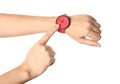 Woman pointing at her watch on white background, closeup. Royalty Free Stock Photo