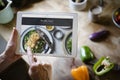 Woman pointing at a screen with heathy foods