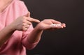 The woman points to the handful of pills in her hand. Royalty Free Stock Photo