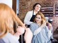 Woman points to master in hairdress salon right hair length for haircut
