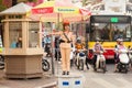 A woman police officer controls traffic on a busy street in Hanoi city