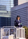 Woman police officer standing on the tower and keeping an order