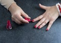 Woman polishing her nails on the gray background. Royalty Free Stock Photo