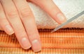 Woman polishing nail using nail file. Manicure concept