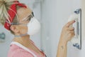 Woman polishing wall with sandpaper