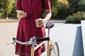 Woman in polka dot dress with bike commuting, checking mail onl Royalty Free Stock Photo