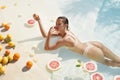 Woman In Pool. Citrus For Perfect Skin And Slim Body. Beautiful Girl In Bikini At Tropical SPA. Royalty Free Stock Photo