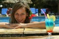 Woman in pool with cocktail Royalty Free Stock Photo