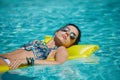 A woman in the pool floats on a blown mattress Royalty Free Stock Photo