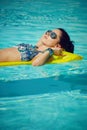 A woman in the pool floats on a blown mattress Royalty Free Stock Photo