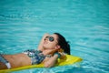 A woman in the pool floats on a blown mattress Royalty Free Stock Photo