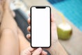 Woman by the pool holding phone with isolated screen Royalty Free Stock Photo