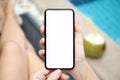 Woman by the pool holding phone with isolated screen Royalty Free Stock Photo