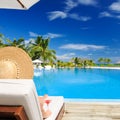 Woman at poolside with cosmopolitan cocktail