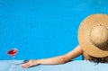 Woman at poolside with cosmopolitan cocktail Royalty Free Stock Photo