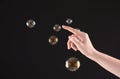 Woman popping soap bubbles on dark background Royalty Free Stock Photo