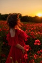 Woman poppy field red dress sunset. Happy woman in a long red dress in a beautiful large poppy field. Blond stands with Royalty Free Stock Photo