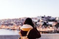 Woman in Porto bridge taking pictures with camera at sunset. Tourism in city Europe. travel Royalty Free Stock Photo