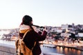 Woman in Porto bridge taking pictures with camera at sunset. Tourism in city Europe. travel Royalty Free Stock Photo