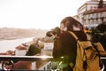 Woman in Porto bridge taking pictures with camera at sunset. Tourism in city Europe. travel Royalty Free Stock Photo