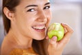 Woman, portrait and apple for hunger in home, organic fiber and fruit for wellness. Happy female person, vitamins and Royalty Free Stock Photo