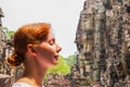 Woman portrait in Bayon temple, Siem Reap, Cambodia. Face of young woman and face of statue.