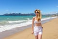 Woman portrait at the beach in Cannes, France. Sunny day. Beautiful Seaside backgrounds