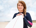 Woman in portrait, beach and surfboard, vacation and surfer on adventure for fitness and travel. Ocean, waves for