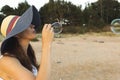 Woman portrait blowing soap bubbles at the beach. Beautiful suns Royalty Free Stock Photo