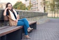 Woman portrait in the city sitted on banch