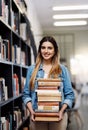 Woman in portrait, college student with stack of books in library and research, studying and learning on university