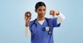 Woman, portrait and doctor with thumbs down, donut and bad review for diet on a blue studio background. Female person Royalty Free Stock Photo