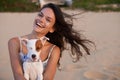 Woman, portrait and dog on beach for happy holiday at sunset for vacation getaway, weekend or bonding. Female person Royalty Free Stock Photo