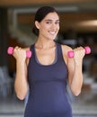 Woman, portrait and dumbbell with weightlifting for fitness in gym with happiness, wellness or healthy body. Athlete